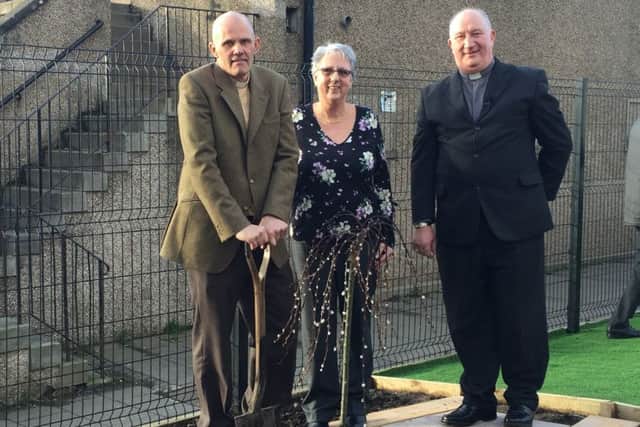 L-R Rev Sean Swindells, Session Clerk Mabel Currie and Rev. Malcolm Muir, planting a commemorative tree at Mayfield & Easthouses Church.