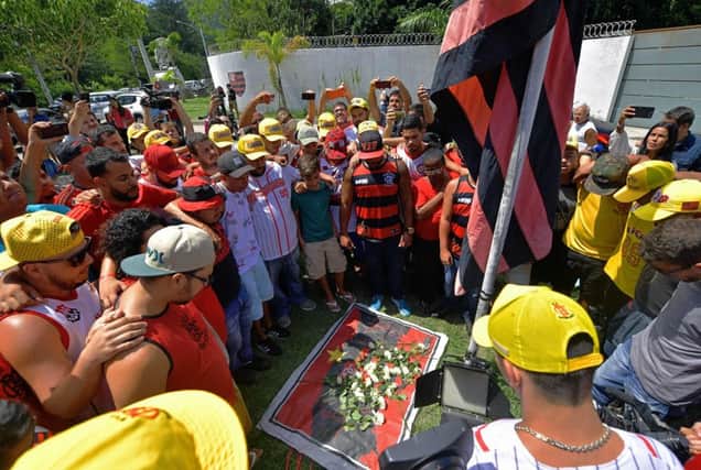 Brazilian football club Flamengo fans gather to lay flowers at the entrance of the club's training center after a deadly fire(Photo by CARL DE SOUZA / AFP)CARL DE SOUZA/AFP/Getty Images