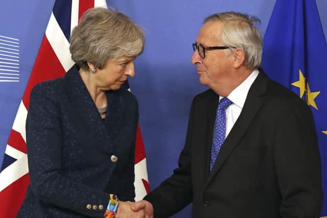 European Commission President Jean-Claude Juncker shakes hands with British Prime Minister Theresa May before their meeting at the European Commission headquarters in Brussels (Picture:Francisco Seco/AP)