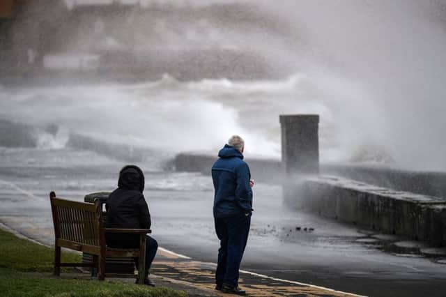Members of the public look on as Storm Erik makes landfall with winds of up to 70mph. (Photo by Jeff J Mitchell/Getty Images)