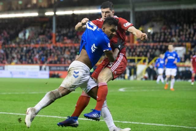 Rangers Alfredo Morelos and Aberdeens Scott McKenna clash. Picture: PA.