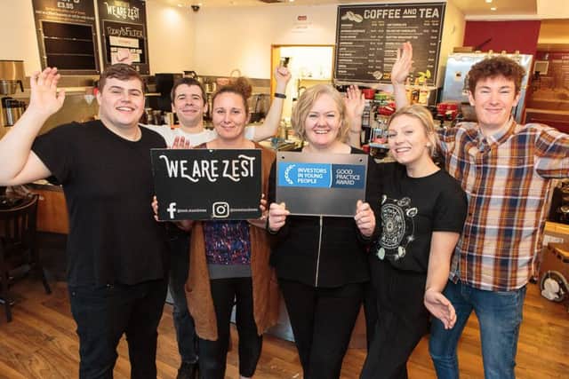 We Are Zest owner Lisa Cathro (4th left) and some of the cafes staff celebrate their IIYP achievement. They are (from left) Lewis Weston, Hamish Hutcheson, manager Caroline White, Olivia Dunderdale and Leo Hector. Picture: Alan S Morrison
