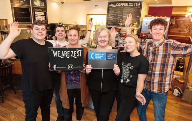 We Are Zest owner Lisa Cathro (4th left) and some of the cafes staff celebrate their IIYP achievement. They are (from left) Lewis Weston, Hamish Hutcheson, manager Caroline White, Olivia Dunderdale and Leo Hector. Picture: Alan S Morrison