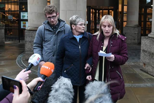 Margaret Hanlon mum (glasses) stands with Lynne Bryce (purple) - the sister of Julie Reilly as they make a statement to the media immediately following the sentencing. Family member Calvin McFarlane looks on. Picture: John Devlin