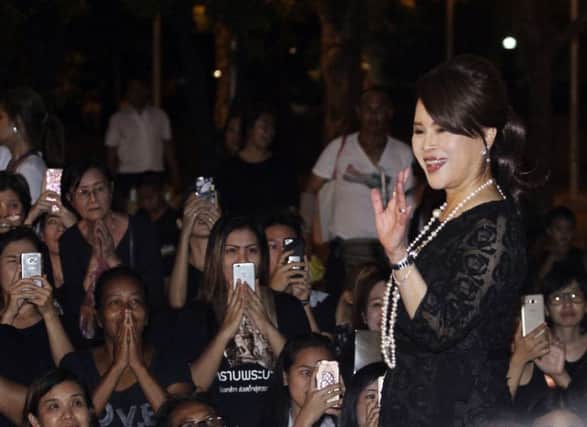 Thai Princess Ubolratana Mahidol waves to Thai people outside Grand Palace in Bangkok , Thailand.  (AP Photo)