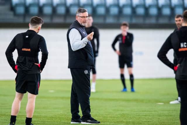 Craig Levein gives instructions to his players at a training session. Picture: SNS.