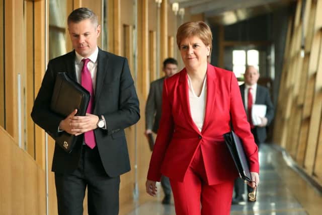 First Minister Nicola Sturgeon with Finance Minister Derek Mackay. Picture: Jane Barlow/PA Wire