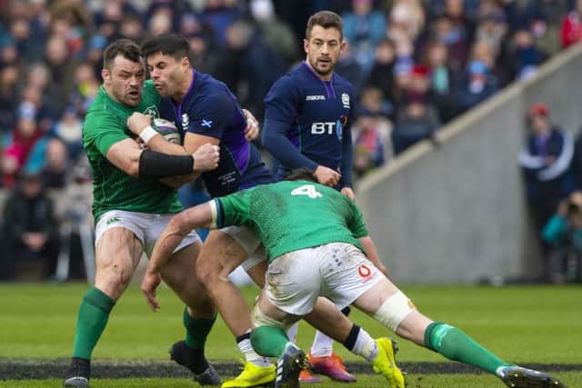 Ireland's Can Healy (left) and James Ryan tackle Scotland's Sean Maitland. Pic: SNS/Bill Murray