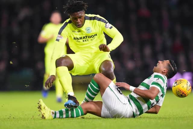 Hibernian's Darnell Johnson was yellow carded for his challenge on Celtic's Emilio Izaguirre. Pic: SNS/Bill Murray