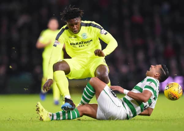 Hibernian's Darnell Johnson was yellow carded for his challenge on Celtic's Emilio Izaguirre. Pic: SNS/Bill Murray