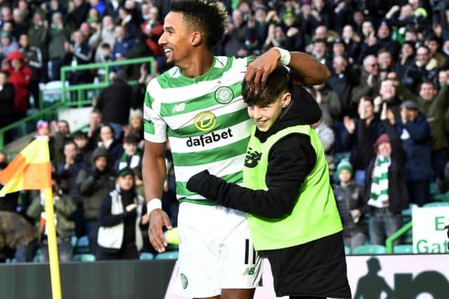 Scott Sinclair celebrates his opening goal with a Celtic Park ballboy. Picture: SNS Group