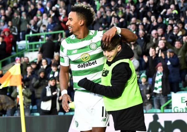 Scott Sinclair celebrates his opening goal with a Celtic Park ballboy. Picture: SNS Group