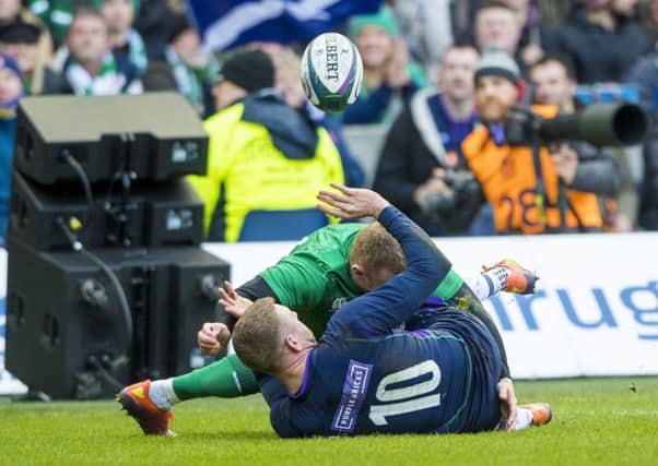 Finn Russell pops up his wonderful offload in the tackle which led to Scotlands only try of the match. Picture: SNS/SRU