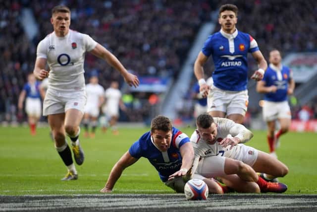 Englands hat-trick hero Jonny May battles Antoine Dupont for possesion during the home sides thumping victory. Picture: Getty.