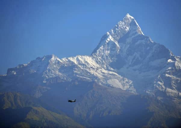 A plane flies by the mighty Mount Machhapuchhare (6,997m) in the Annapurna range near Sarangkot, Pokhara (Picture: Jane Barlow)