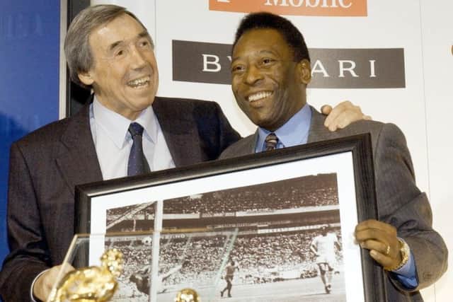 Gordon Banks will always be remembered for his save against Pele. The pair are pictured here in 2004 with a framed picture of the famous moment. Picture: PA.