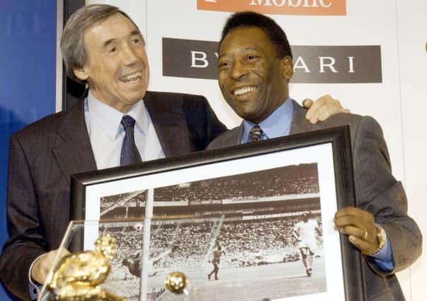 Gordon Banks will always be remembered for his save against Pele. The pair are pictured here in 2004 with a framed picture of the famous moment. Picture: PA.
