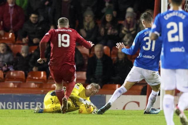 Allan McGregor challenges Lewis Ferguson of Aberdeen during Rangers' recent 4-2 win at Pittodrie. Picture: SNS
