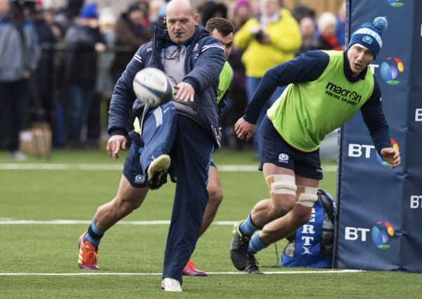 Scotland coach Gregor Townsend kicks ahead for flanker Jamie Ritchie to chase at a training session in Clydebank