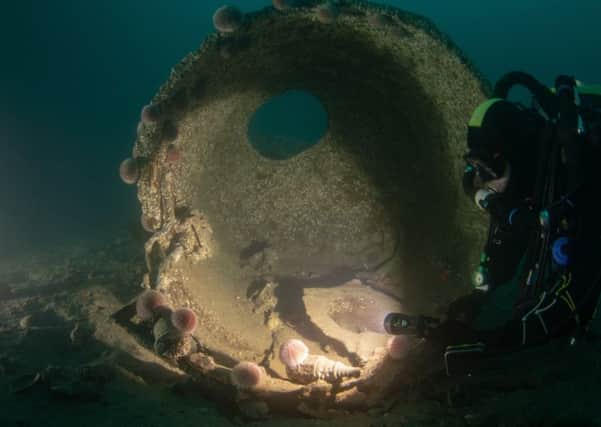 A driver examines remains of the SMS Derfflinger which was known as the Iron Dog by the British Navy given its resillience. PIC: Bob Anderson.