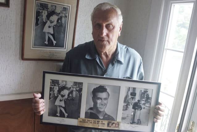 George Mendonsa in 2009 with a copy of the iconic photograph. (Picture: Connie Grosch/Providence Journal via AP)