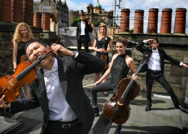 Members of the Catalonian string orchestra Orquestra de Cambra d'Emporda, who combine classical music with pop songs and mime, pose in Edinburgh (Picture: Jeff J Mitchell/Getty Images)