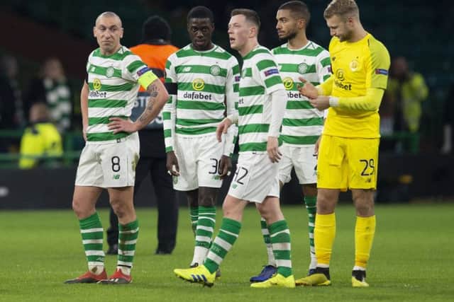 The Celtic players look dejected at full-time. Picture: SNS