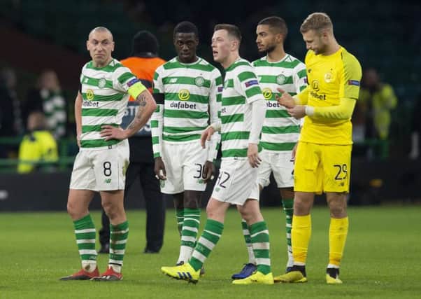 The Celtic players look dejected at full-time. Picture: SNS