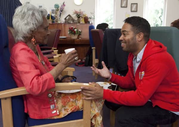 Ambassador for the People's Postcode Lottery, Danyl Johnson, visits users of the Carers Trust service. Photograph: Getty