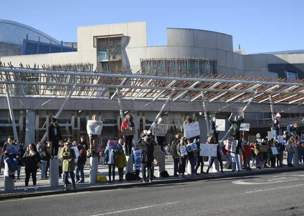 Striking pupils gather outside the Scottish Parliament on Friday. Picture: Greg Macvean