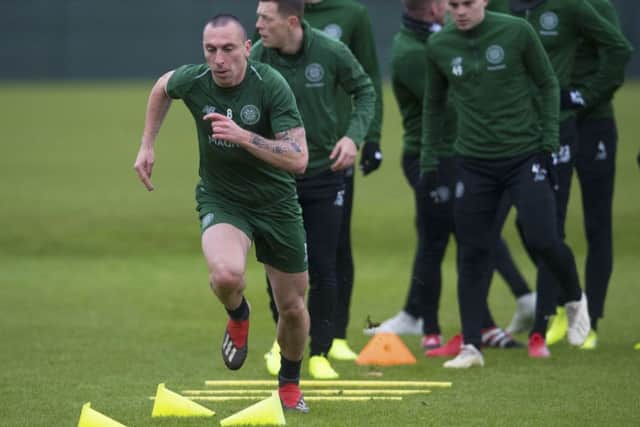 Veteran Scott Brown leads off a Celtic training session yesterday, but the captain visibly struggled against Valencia in midweek. Picture: SNS.