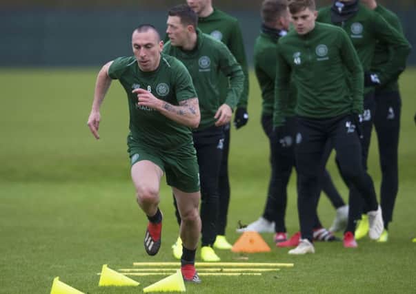 Veteran Scott Brown leads off a Celtic training session yesterday, but the captain visibly struggled against Valencia in midweek. Picture: SNS.