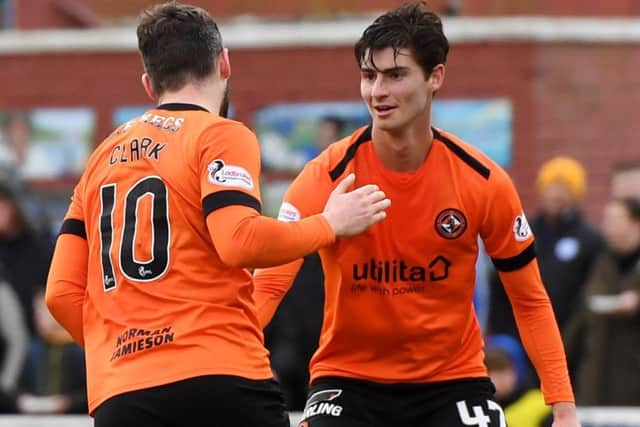 Dundee United's Nicky Clark celebrates with Ian Harkes after opening the scoring from the penalty spot. Pic: SNS/Gary Hutchison