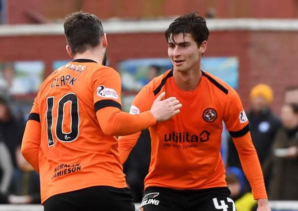 Dundee United's Nicky Clark celebrates with Ian Harkes after opening the scoring from the penalty spot. Pic: SNS/Gary Hutchison