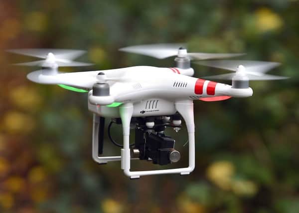 A wedding photographer who proposed to his girlfriend by drone has been fined after he was caught flying the craft over Edinburgh city centre. Picture: Joe Giddens/PA Wire