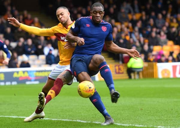 Motherwell's Charles Dunne battles for possession with Uche Ikpeazu of Hearts. Picture: SNS Group