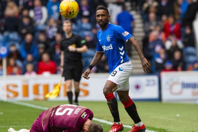 St Johnstone's Joe Shaughnessy goes down under a challenge from Jermain Defoe