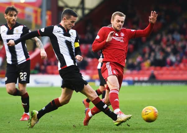Paul McGinn plays the ball under pressure from Aberdeen forward James Wilson. Picture: SNS Group