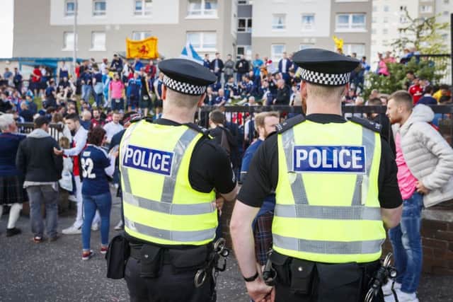 Police watch over football fans. Picture: SNS/Roddy Scott