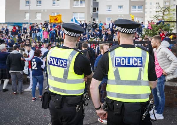 Police watch over football fans. Picture: SNS/Roddy Scott