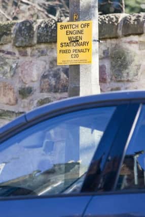 Parking notice outside Scottish primary where a £20 fine is issued for cars with the engine running