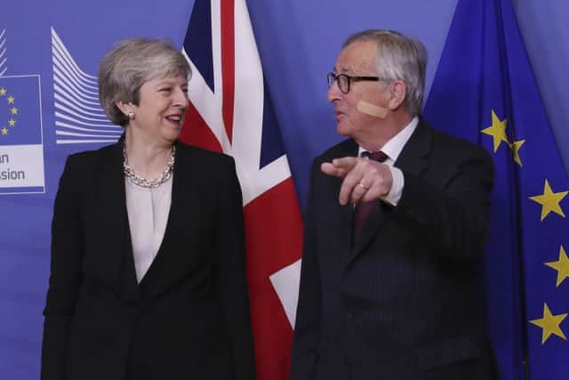 British Prime Minister Theresa May, left, is greeted by European Commission President Jean-Claude Juncker. (AP Photo/Francisco Seco)