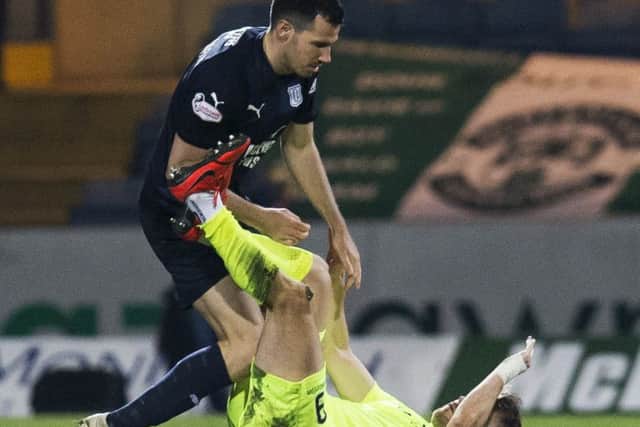 Hibernian's Marc McNulty clashes with Dundee's Ryan McGowan. Picture: SNS