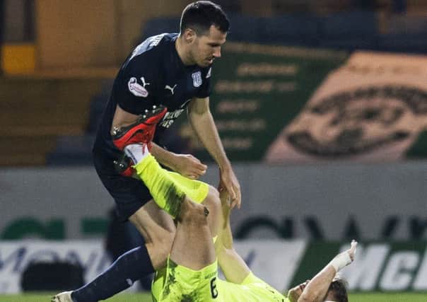 Hibernian's Marc McNulty clashes with Dundee's Ryan McGowan. Picture: SNS