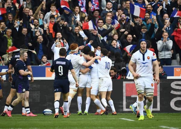 France's winger Yoann Huget (C) celebrates with teammates after scoring a try. Pic: Anne-Christine Poujoulat /AFP/Getty