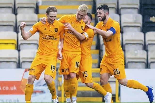 Livingston's Chris Erskine celebrates his opener with Craig Sibbald. Pic: SNS/Roddy Scott