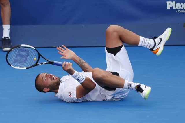 Dan Evans takes a tumbles during the final of the Delray Beach Open. Picture: Wilfredo Lee/AP