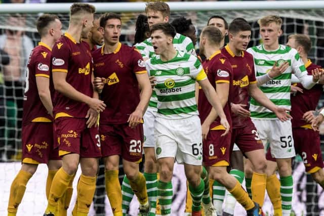 Celtic's Kieran Tierney has words with James Scott after the Motherwell player ran in on goal rather than returning the ball to the hosts following a break in play. Picture: Alan Harvey/SNS