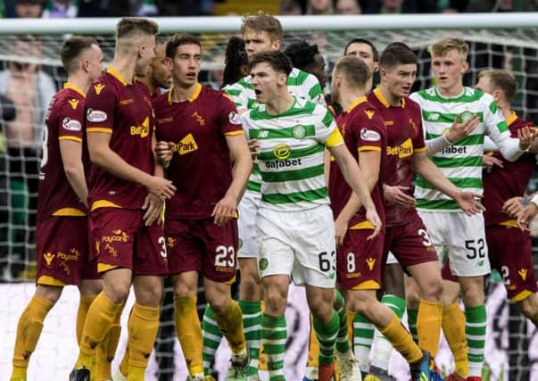 Celtic's Kieran Tierney has words with James Scott after the Motherwell player ran in on goal rather than returning the ball to the hosts following a break in play. Picture: Alan Harvey/SNS