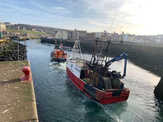 Eyemouth lifeboat tows a trawler into the harbour after it suffered engine failure.